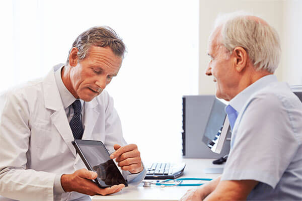 A doctor discusses eye surgery options with a patient